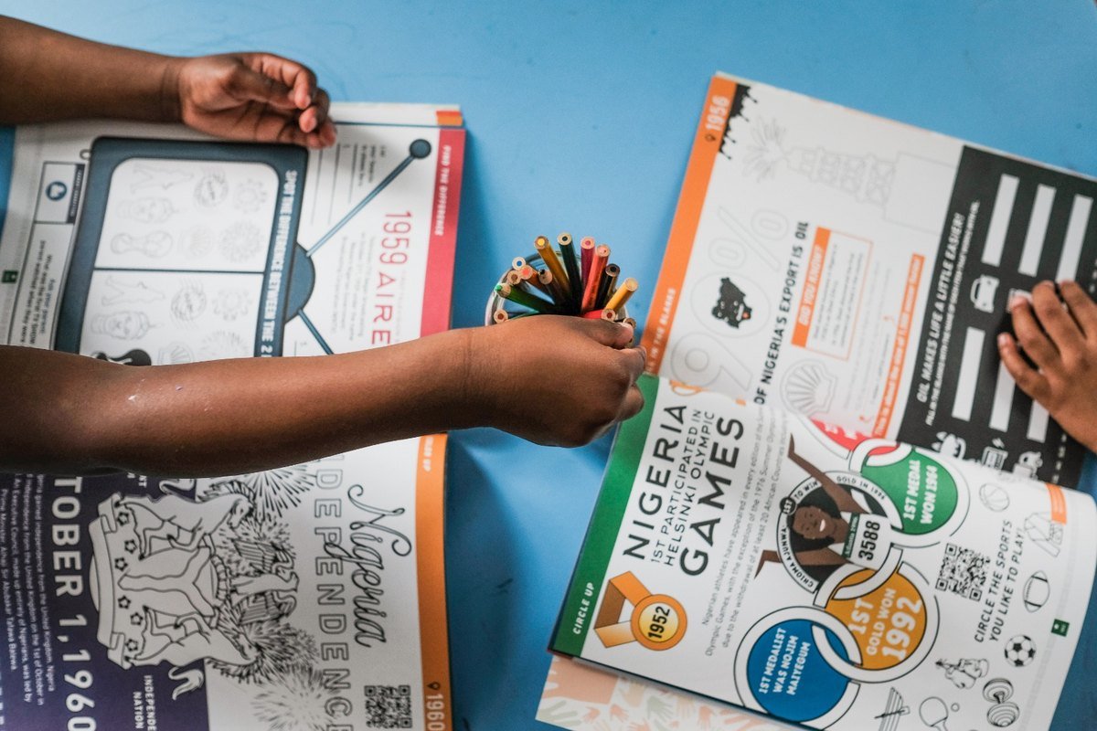Two children colouring the Olympic Games and Independence spreads
