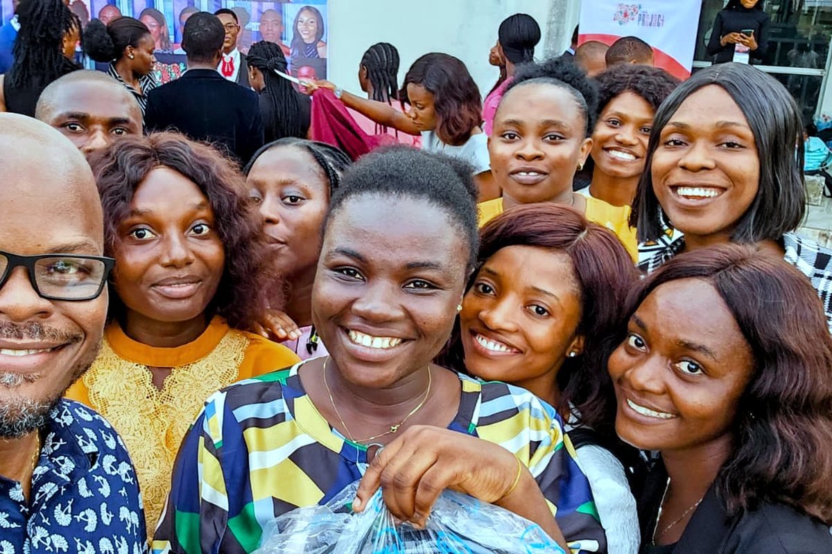 Mobolaji with graduating participants outside a 234 Project event